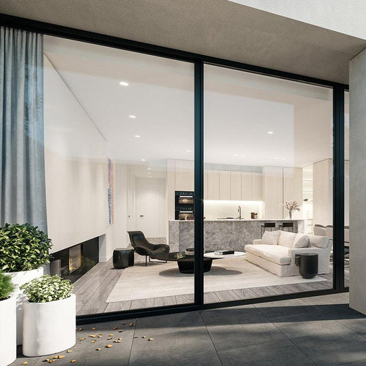 127 sliding door with dark aluminium frames beside a furnished living room